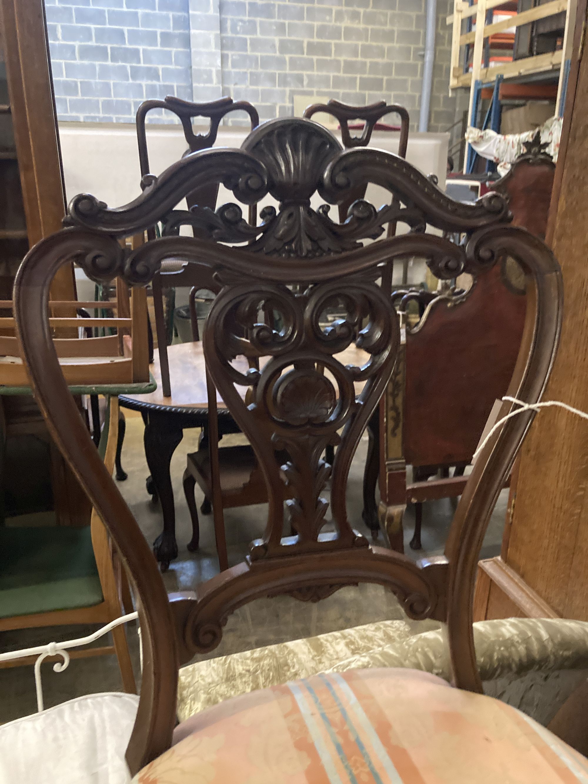 A pair of Victorian walnut dining chairs, on cabriole legs